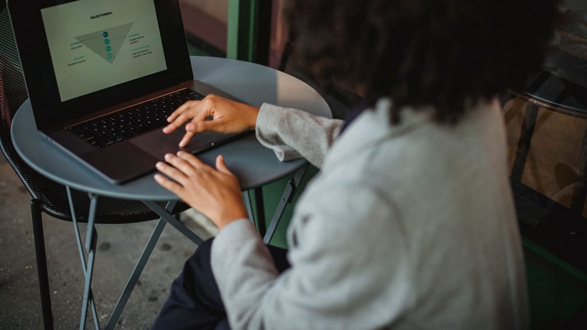 Young woman working on a laptop showing a sales funnel diagram
