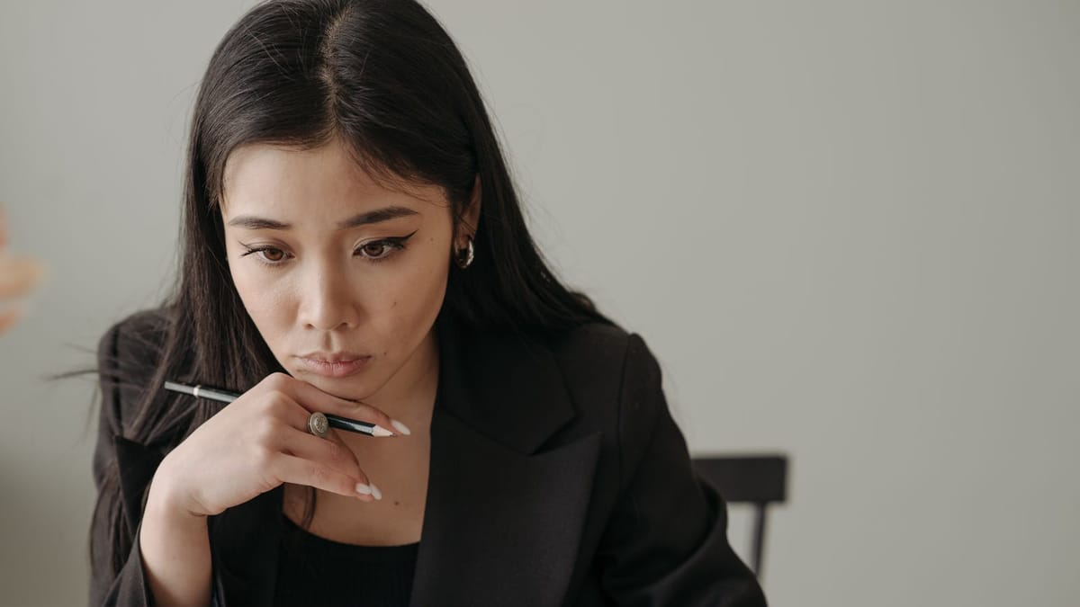 Young woman carefully reviewing something at a desk